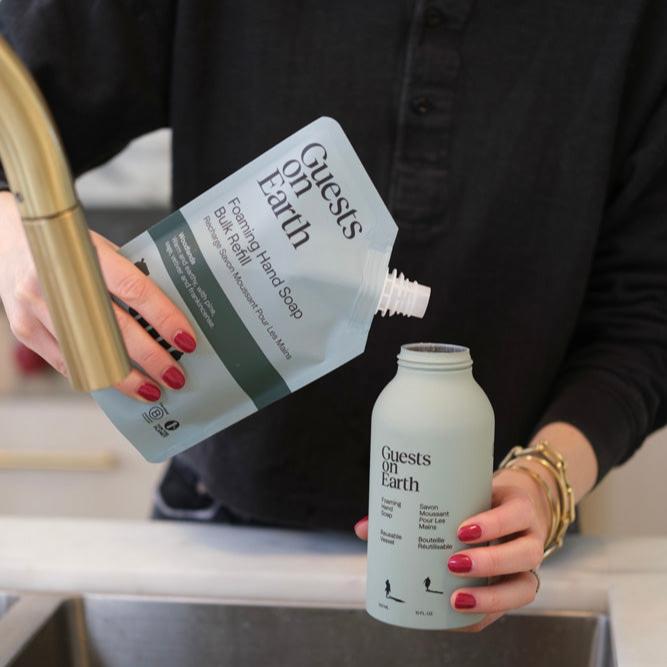 Guests on Earth Foaming Hand Soap Bulk Refill poured from pouch into reusable bottle at the sink for easy, low-waste topping up