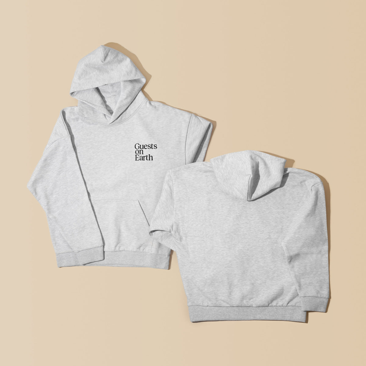 Guests on Earth Hoodie in heather grey, shown front and back with minimalist chest logo on a beige backdrop