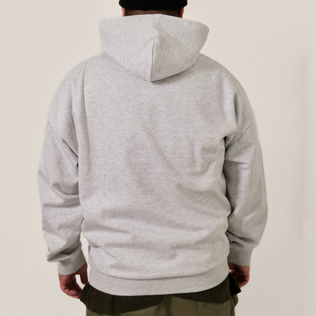 Guests on Earth Hoodie back view in heather grey, relaxed fit with hood up, clean unbranded back panel