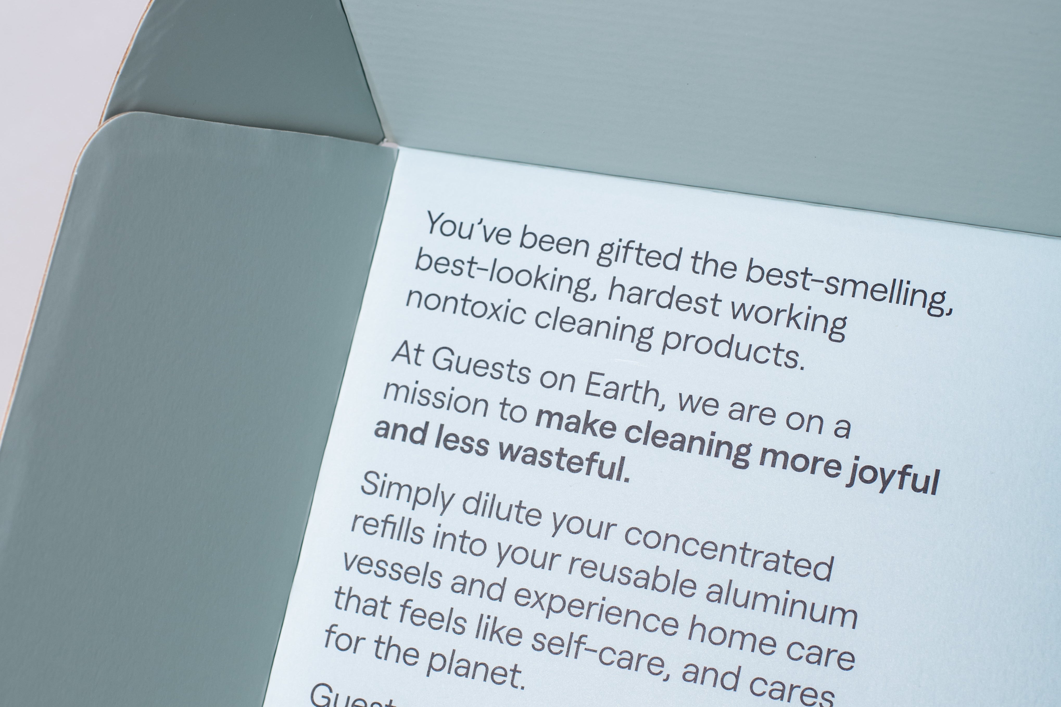 Inside Guests on Earth Gift Box, printed note explains non-toxic refills and reusable aluminium vessels for joyful, low-waste cleaning.