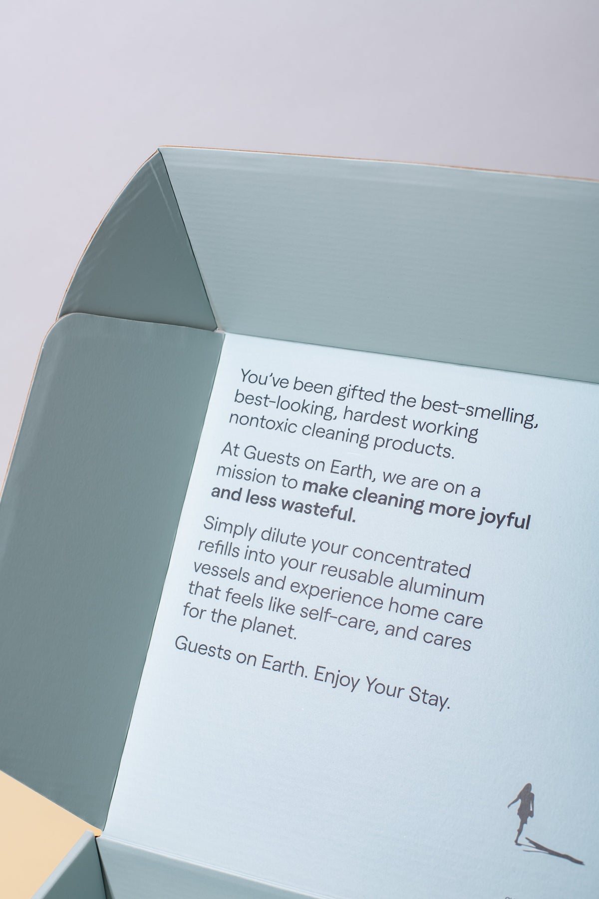 Inside Guests on Earth Gift Box, printed note explains non-toxic refills and reusable aluminium vessels for joyful, low-waste cleaning.